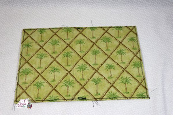 Knowing that I'll be creating a junk journal for Sea Breeze by Calico Collage I dug around in my fabric stash and found this fun palm tree fabric. The cover measures 13.5 inches wide by 9 inches tall when laid flat. It is designed to fit 3 to 4 journal inserts that measure 5.5 inches wide by 8.5 inches tall. Has two inside pockets to add items.
